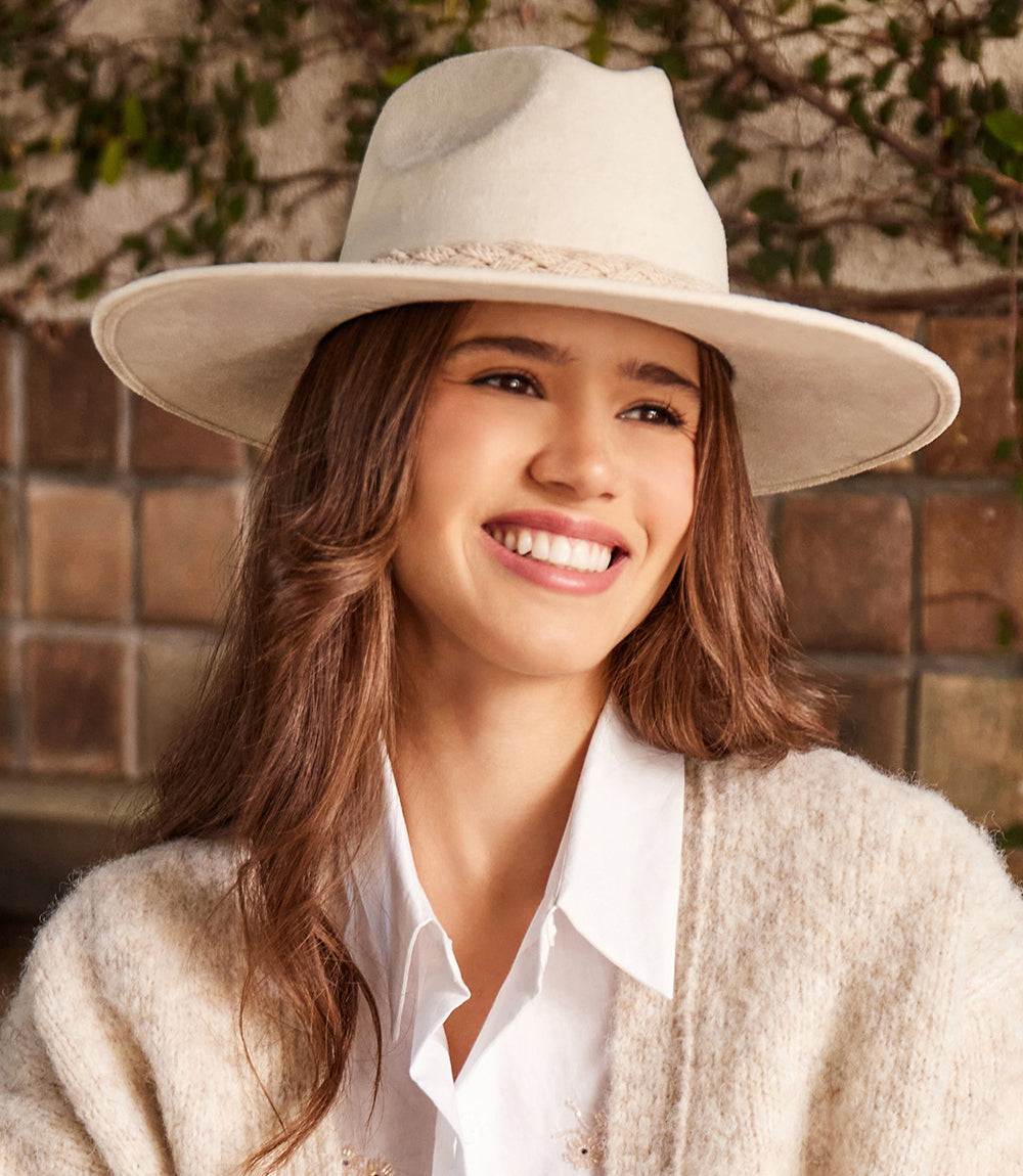 Cream braided trim fedora hat made from polyester suede worn by smiling woman