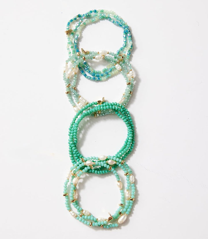 Crystal beaded stretch bracelet in shades of teal and white, designed to be worn as a bracelet or necklace.