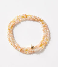 Crystal beaded stretch bracelet in soft pink and golden hues, wearable as bracelet or necklace for versatile style.