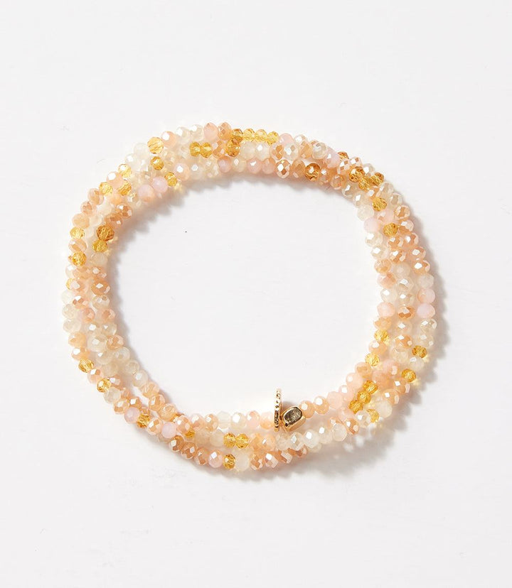 Crystal beaded stretch bracelet in soft pink and golden hues, wearable as bracelet or necklace for versatile style.