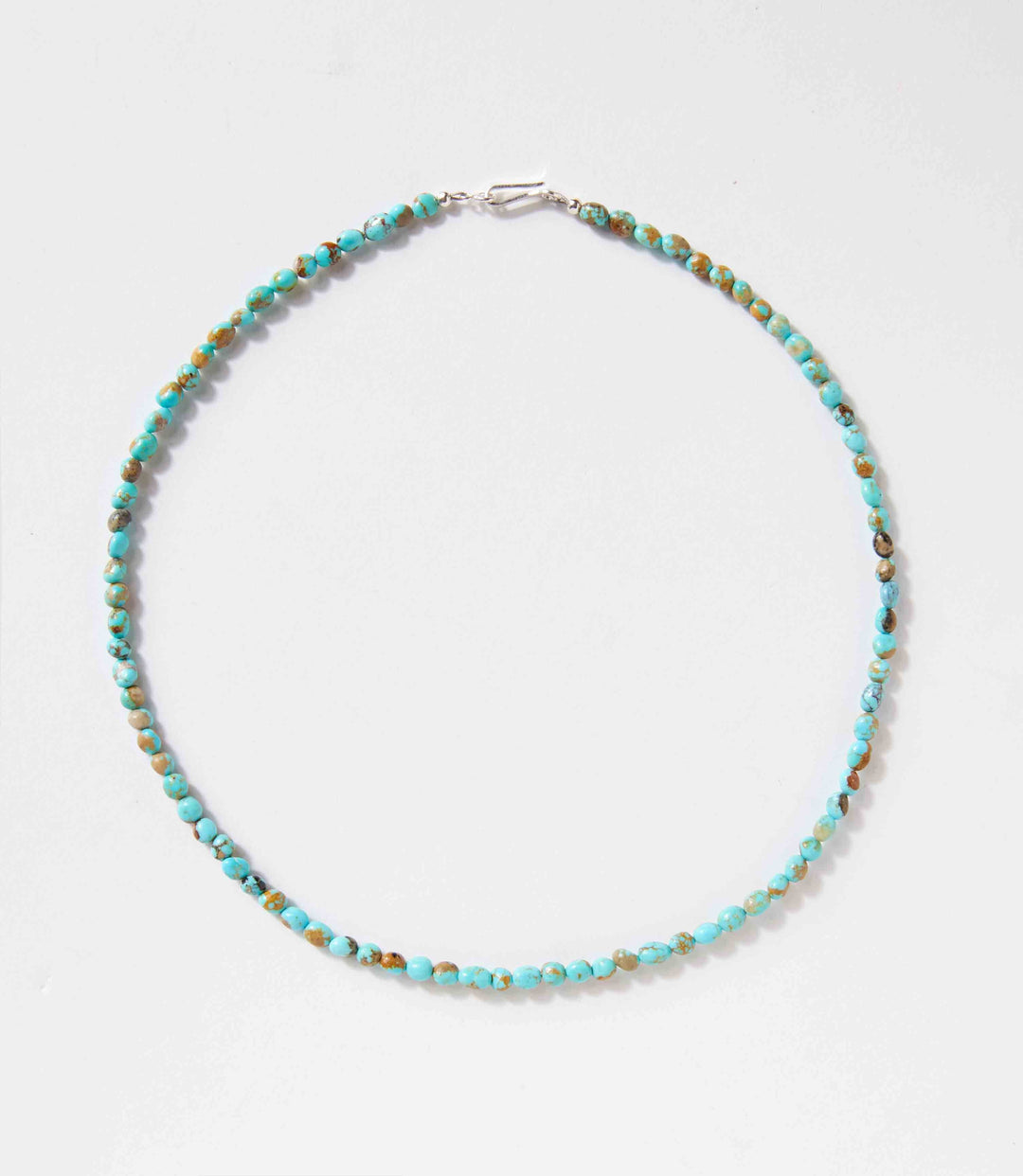 Turquoise beaded necklace with sterling silver clasp handcrafted by Navajo artists, 18 inches long, unique natural stones.