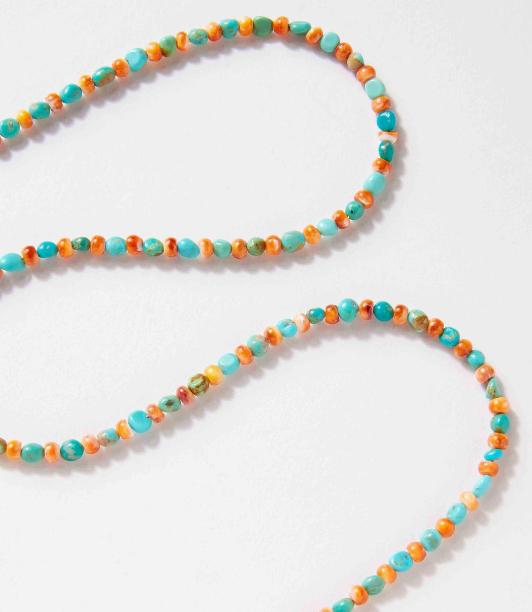Turquoise and spiny oyster beaded necklace handcrafted with sterling silver accents.