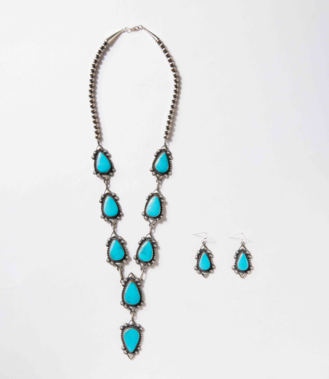 Turquoise stone lariat necklace and earrings set with sterling silver handcrafted by Navajo artist Derrick Gordon