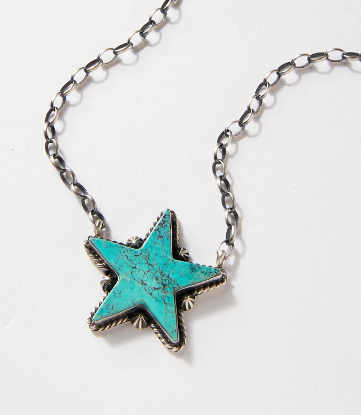 Turquoise Star Necklace with sterling silver chain and vibrant turquoise star pendant showcasing southwestern design.