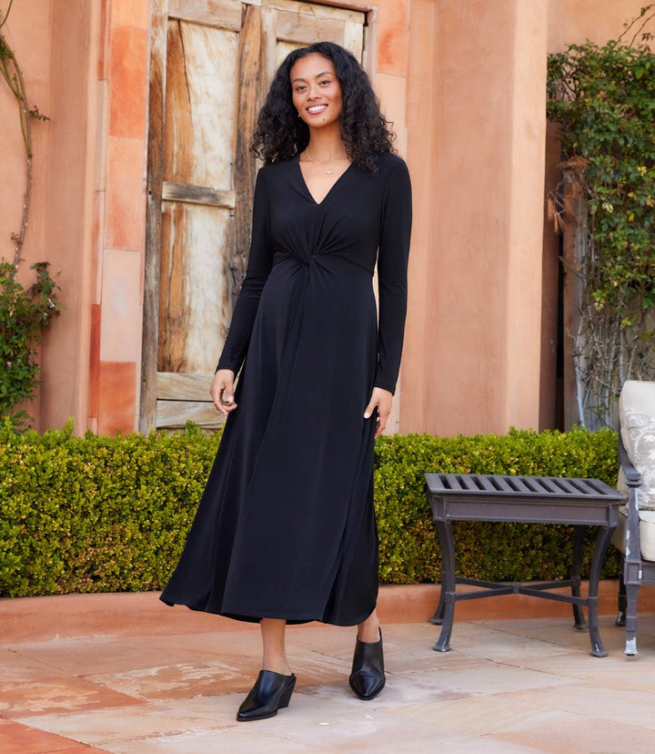 Monroe Travel Jersey black twist front midi dress with long sleeves and V-neck worn outdoors