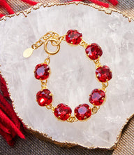 Large crystal bracelet with oversized red Swarovski crystals and 14K gold finish in a polished design