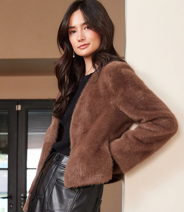 woman wearing brown reversible faux fur jacket with long sleeves and open front