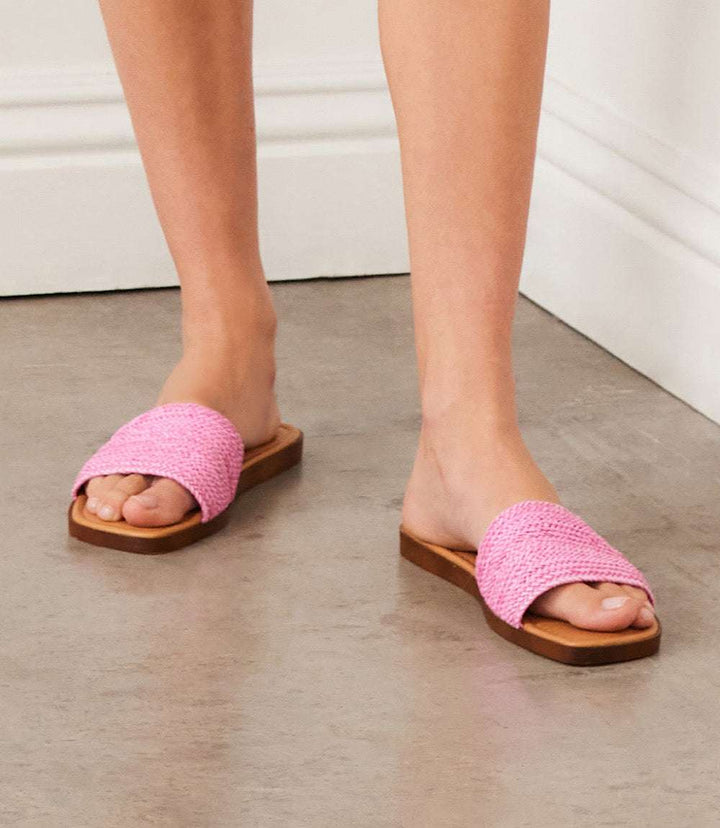 Pink Palms Perfection Sandals with raffia upper and square toe flat heel style worn on feet