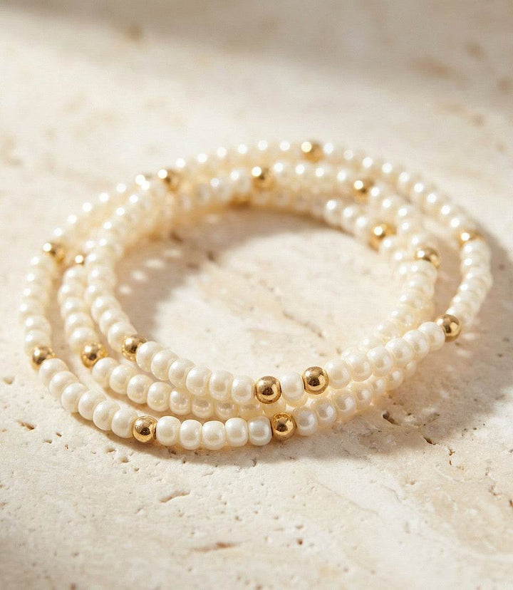Set of 3 beaded crystal bracelets with pearl-white glass beads and gold-filled accents in a stretchy design