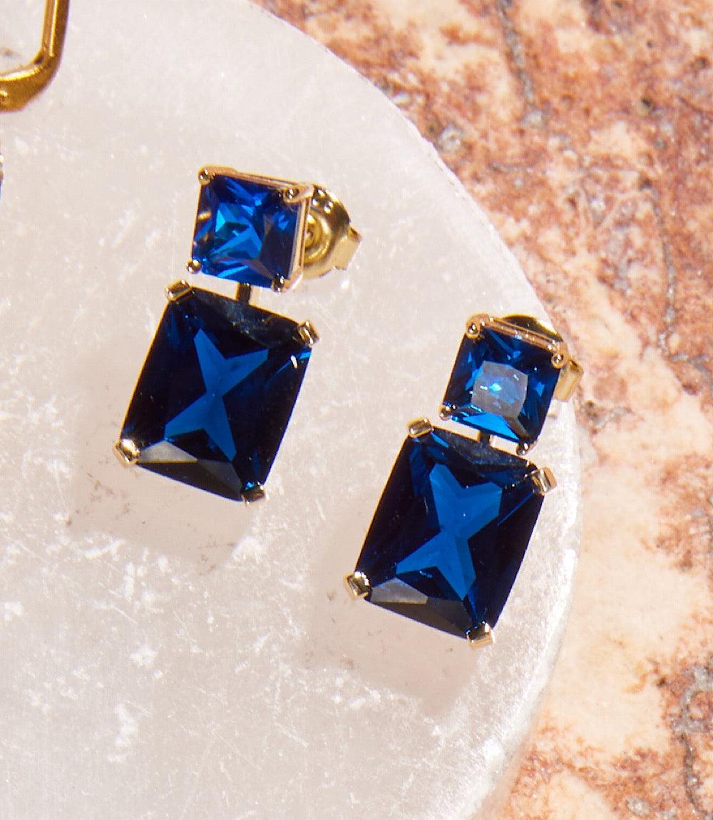 Gold over brass princess cut drop earrings with stacked sapphire blue cubic zirconia stones