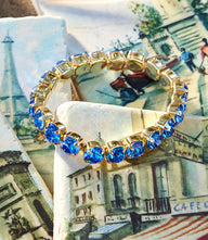 Crystal Stretch Bracelet with sapphire blue crystals and gold plating on brass base metal