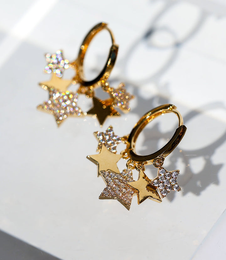 14K gold Star Huggie Earrings with cubic zirconia star charms, hypoallergenic and lightweight