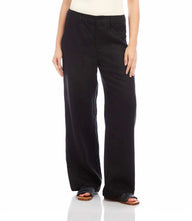 Black linen wide-leg trousers with button zipper closure and front pockets worn by model