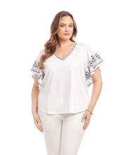 Plus size embroidered flutter sleeve top with V-neck and navy blue embroidery on white organic cotton fabric