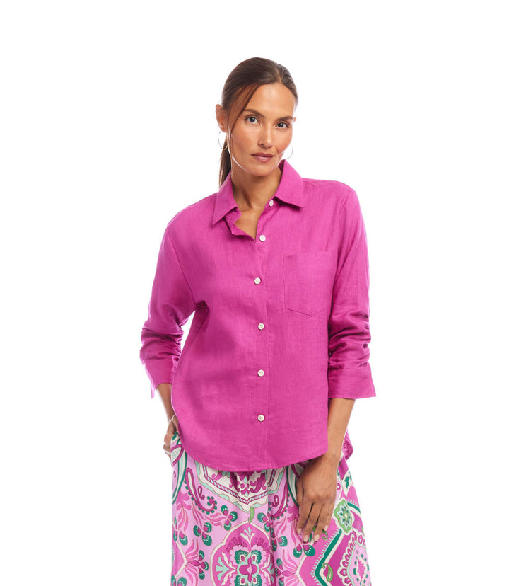 Woman wearing pink linen ruched sleeve shirt with front buttons and collar