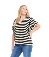 Plus size stripe flutter sleeve V-neck top in relaxed fit with black and white stripes and casual jeans