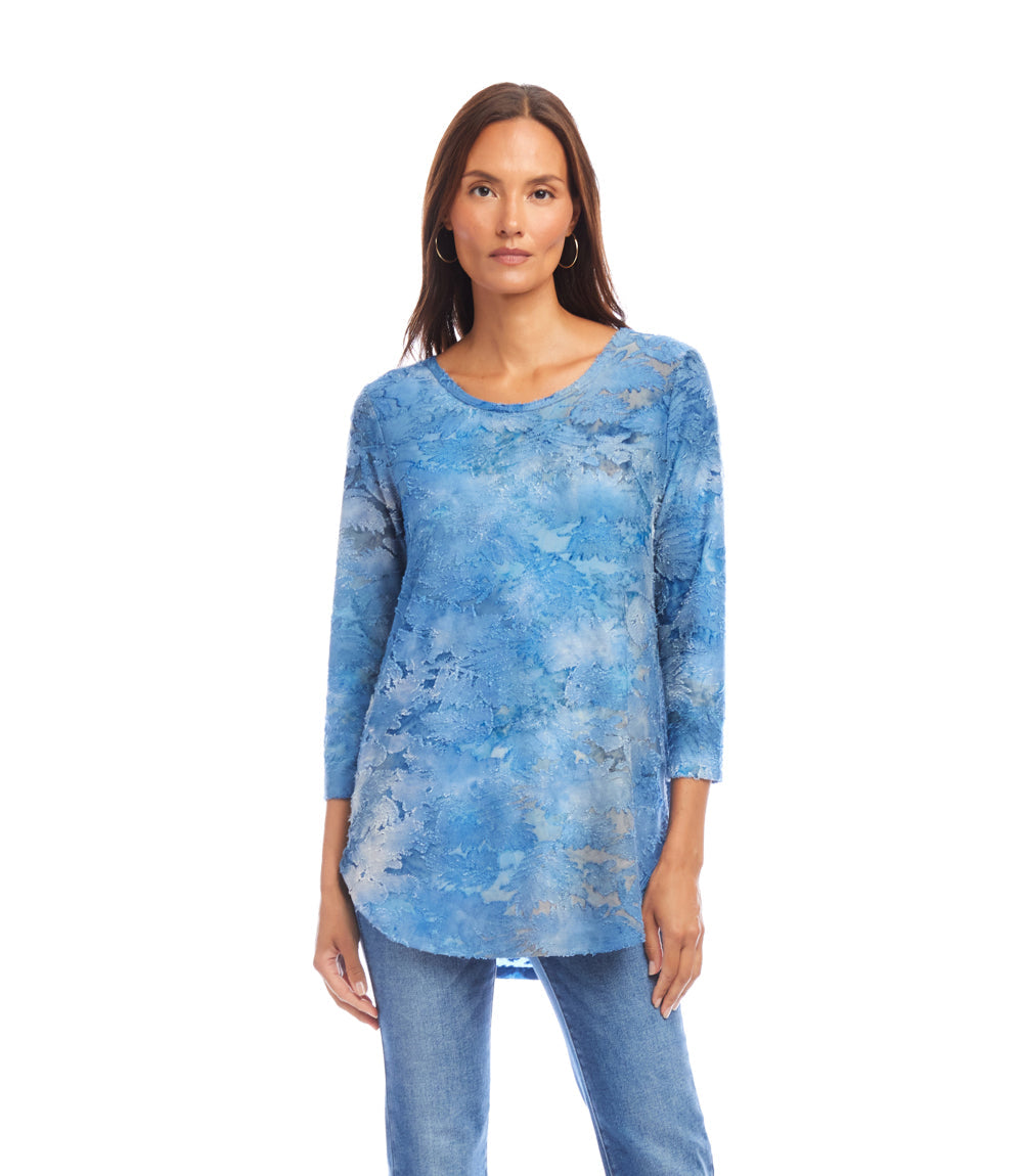 Woman wearing blue tie-dye 3/4 sleeve burnout shirttail top with scoop neck and relaxed fit