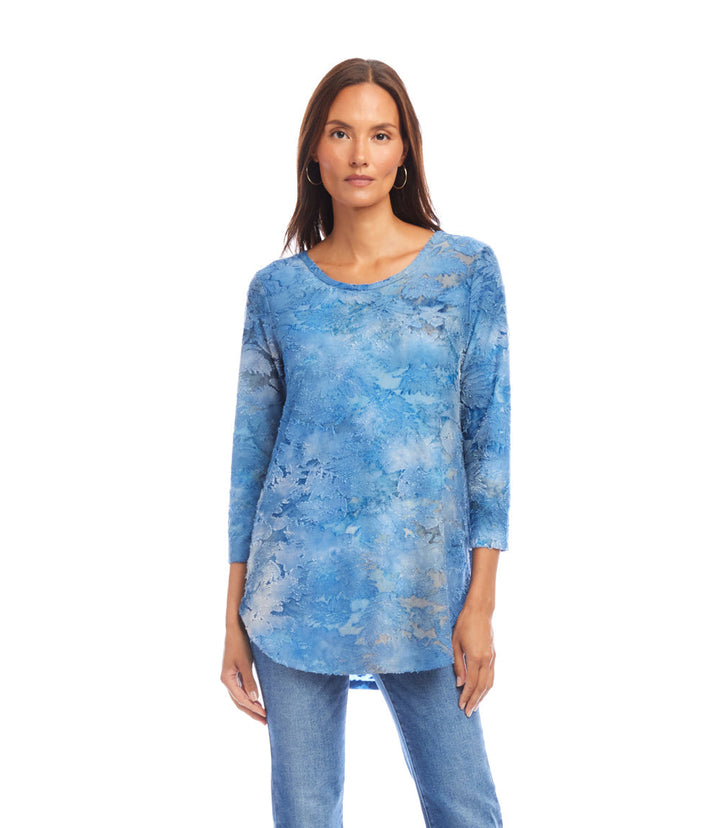 Woman wearing blue tie-dye 3/4 sleeve burnout shirttail top with scoop neck and relaxed fit