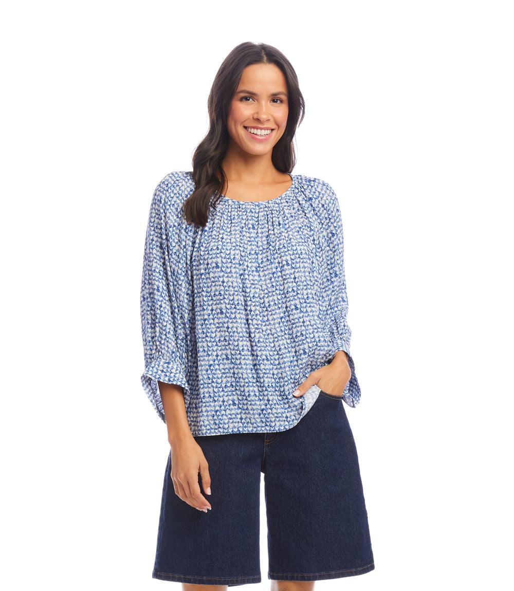 Woman wearing a blue Blouson Sleeve Top with white heart crepe print and dark denim shorts