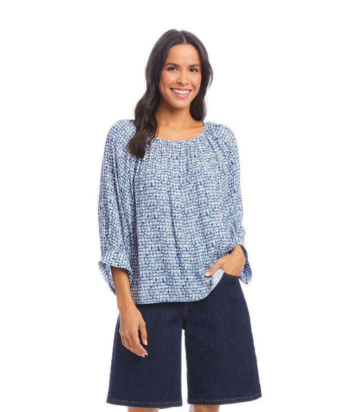 Woman wearing a blue Blouson Sleeve Top with white heart crepe print and dark denim shorts