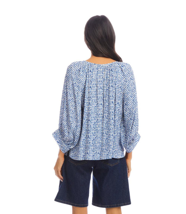 Back view of woman wearing blue heart print Blouson Sleeve Top with relaxed fit and flowy design