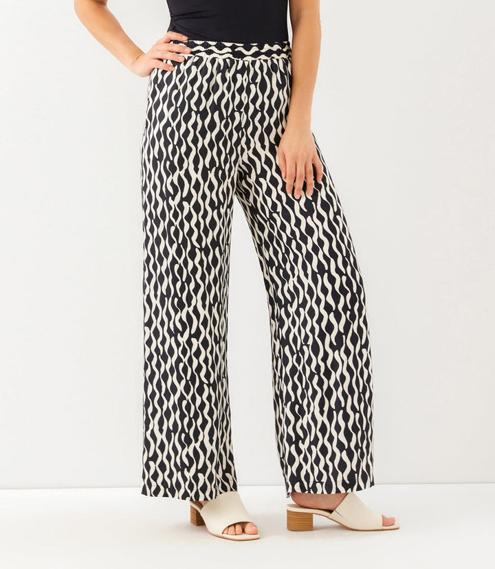 Black and cream satin wide-leg pants with wavy stripe print and elastic waistband