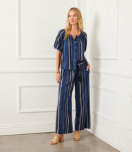 Petite size embroidered cropped pants in navy blue with cream stripes, elastic waist, drawstring, side pockets, and wide leg design.
