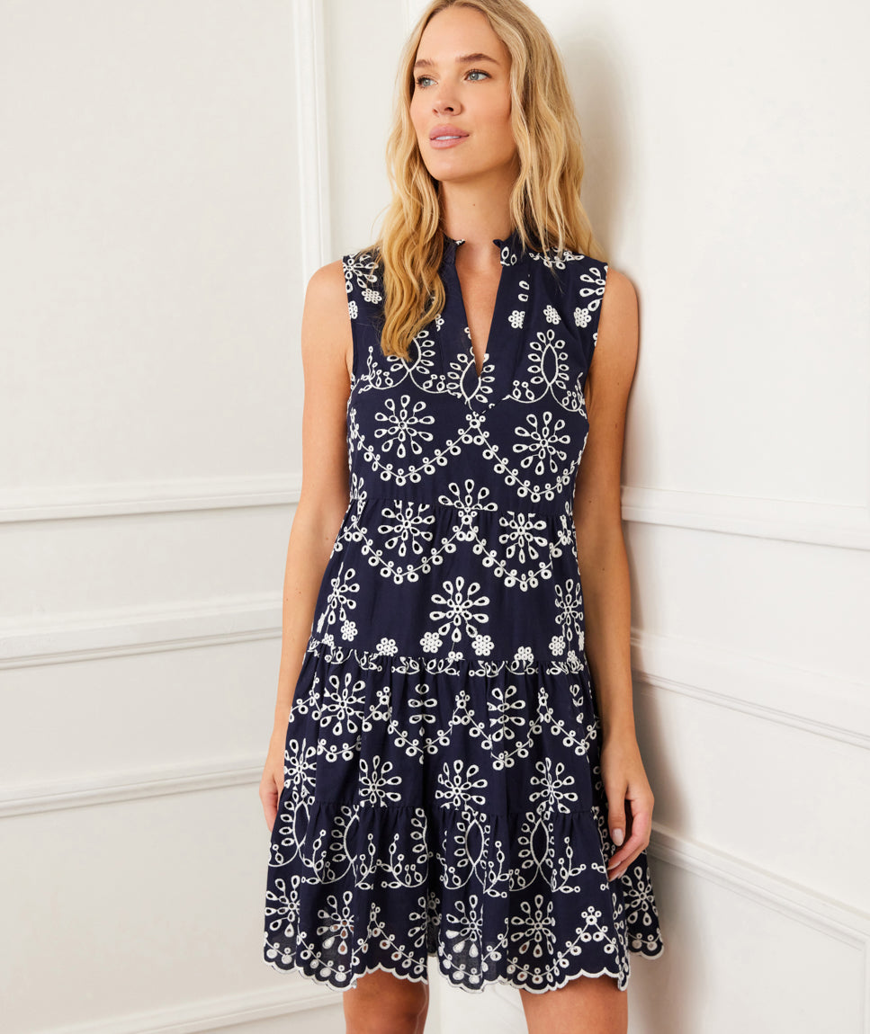 Petite size sleeveless navy dress with off-white eyelet embroidery, mandarin collar, split neckline, and tiered skirt.