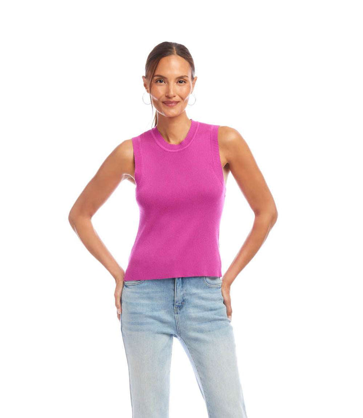 Woman wearing sleeveless ribbed sweater tank in pink with jeans