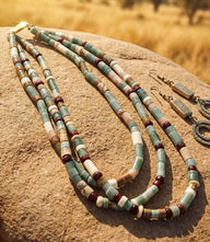 Layered turquoise bead necklace with gold accents and multiple strands