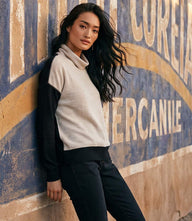 Ribbed long sleeve colorblock turtleneck top with oatmeal and black panels, soft brushed knit fabric, and relaxed fit
