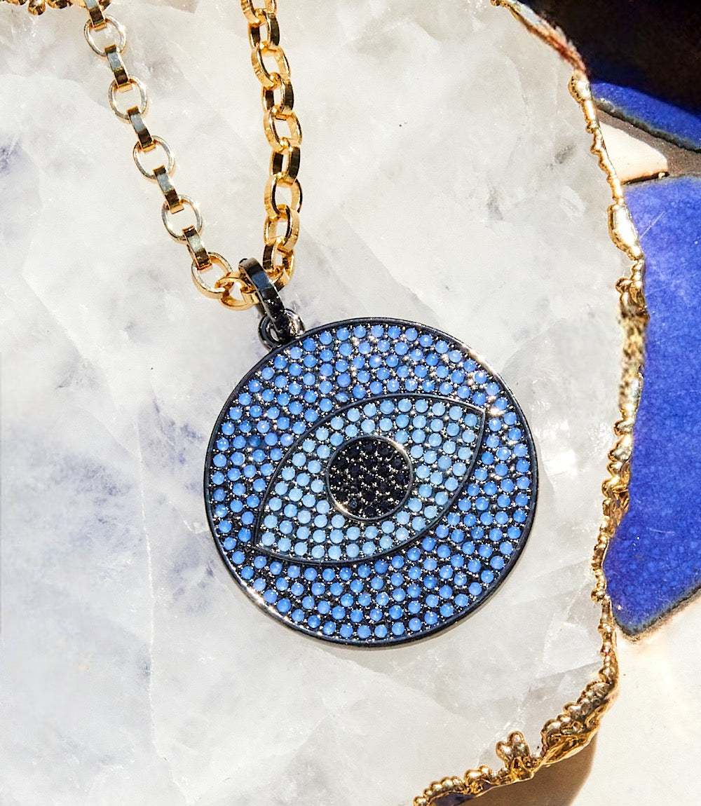 Pavé crystal pendant necklace with navy-blue evil eye motif on gold rolo chain