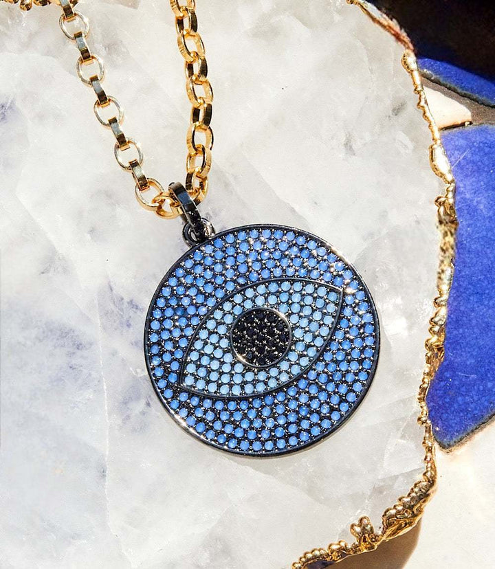 Pavé crystal pendant necklace with navy-blue evil eye motif on gold rolo chain