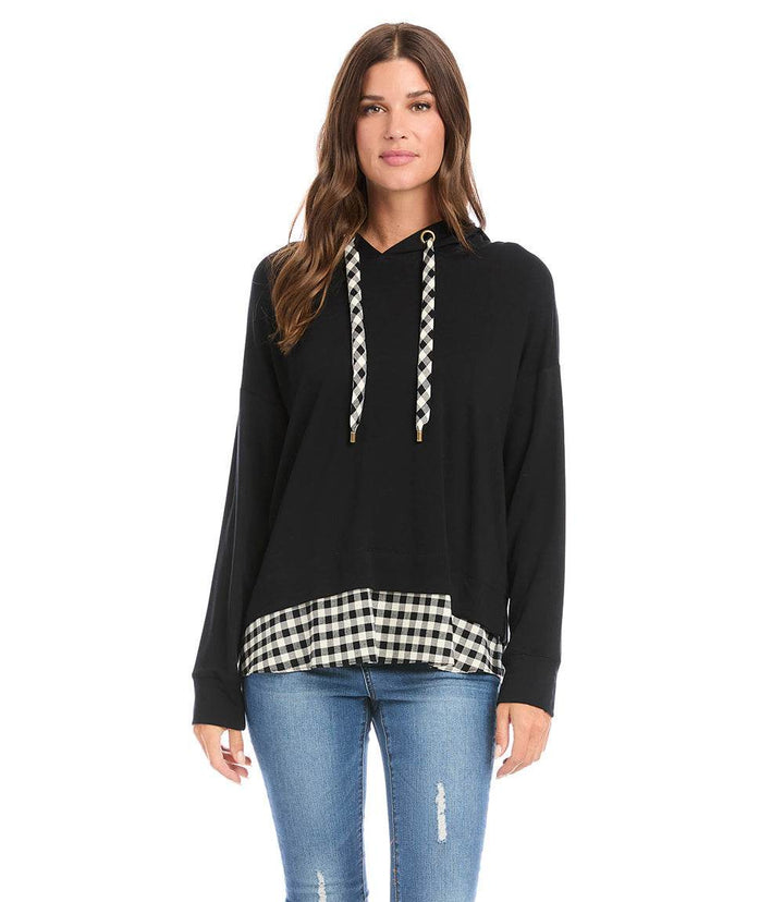 Woman wearing black Contrast Hem Hoodie with buffalo check hem and matching drawstrings, paired with blue jeans
