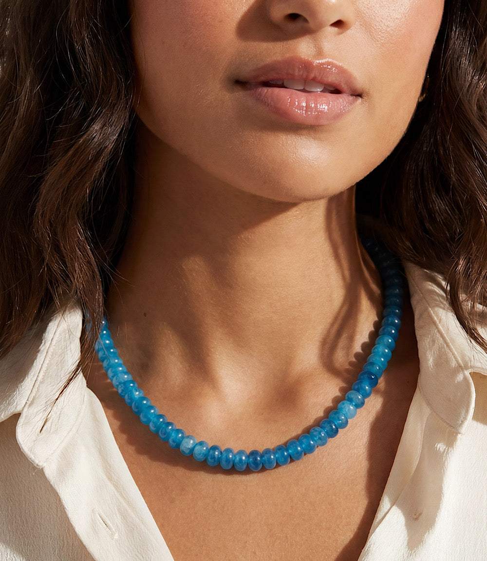 Beaded necklace with smooth dark blue quartz beads, 18K gold plated brass, lobster clasp, and adjustable extender