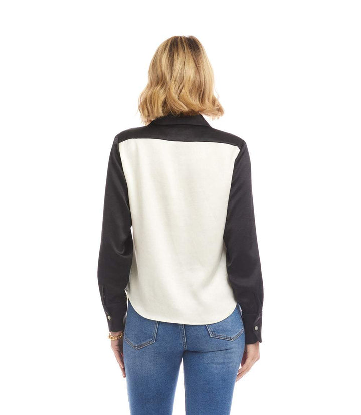 Back view of long sleeve satin colorblock shirt with black sleeves and collar and white back panel worn with blue jeans