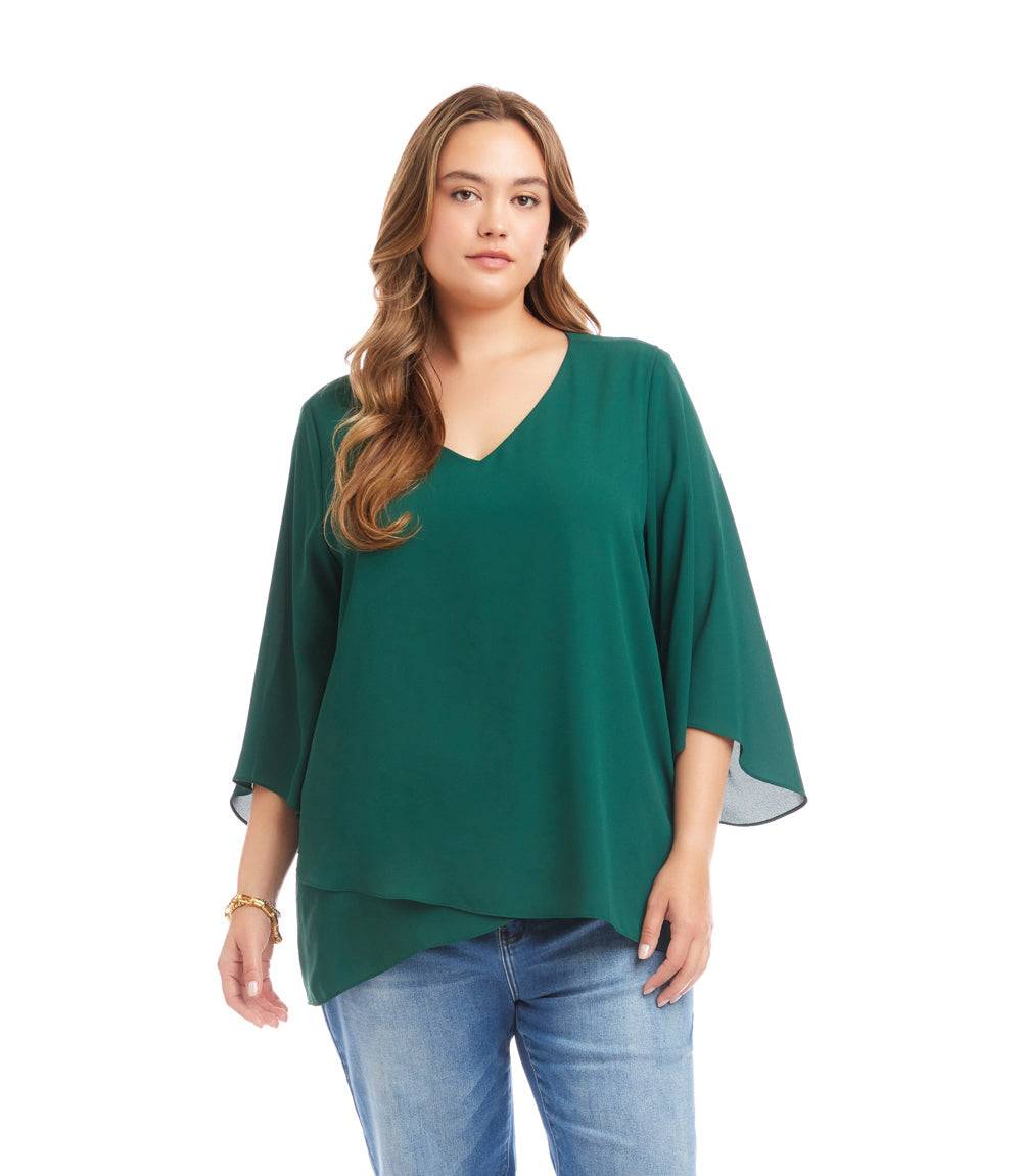 Plus size bracelet sleeve asymmetric top in green silky crepe with V-neck and layered hem