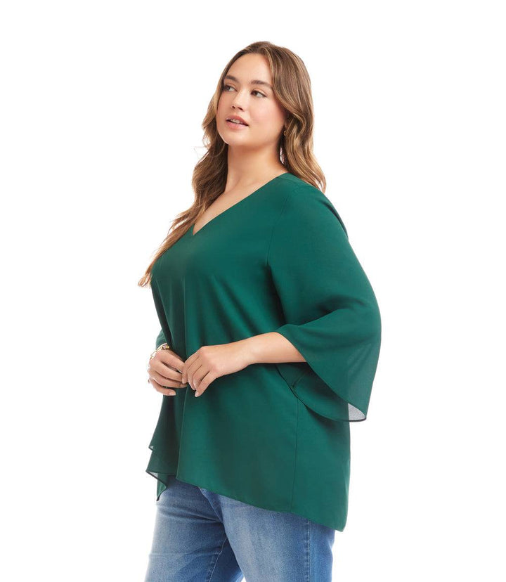 Plus size bracelet sleeve asymmetric green top with layered hem and V-neck, paired with blue jeans