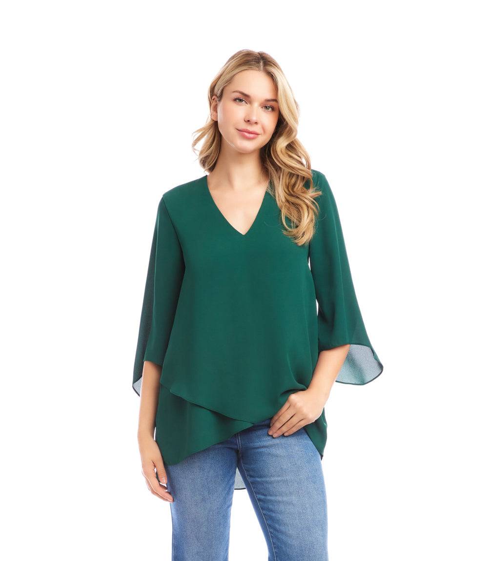 Petite size green asymmetric bracelet sleeve top with V-neck and layered hem made of silky crepe fabric.