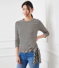 Woman wearing a striped 3/4 sleeve side-tie top with crew neck and relaxed fit
