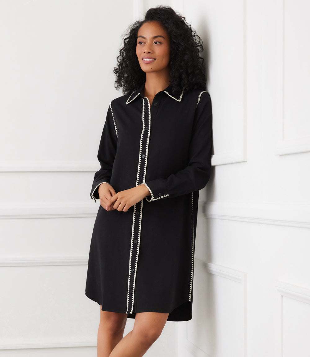 Black long sleeve shirtdress with cream edge stitching, button front, and classic collar.