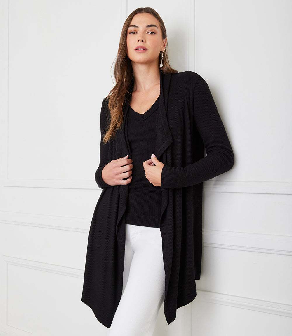 Petite size long sleeve ribbed black cardigan with draped open front and high-low hem.