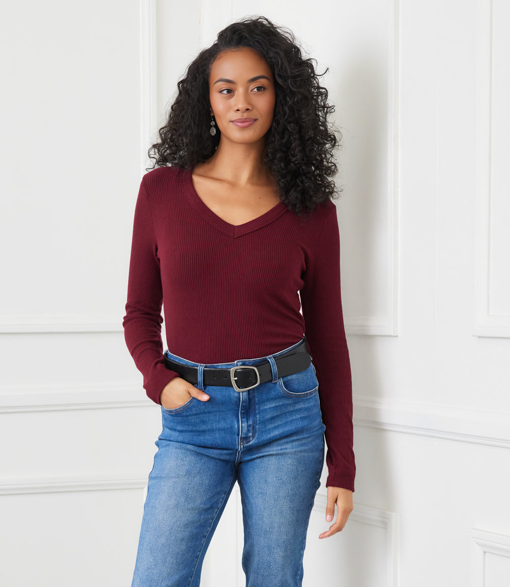 Petite size long sleeve V-neck ribbed top in burgundy worn with blue jeans