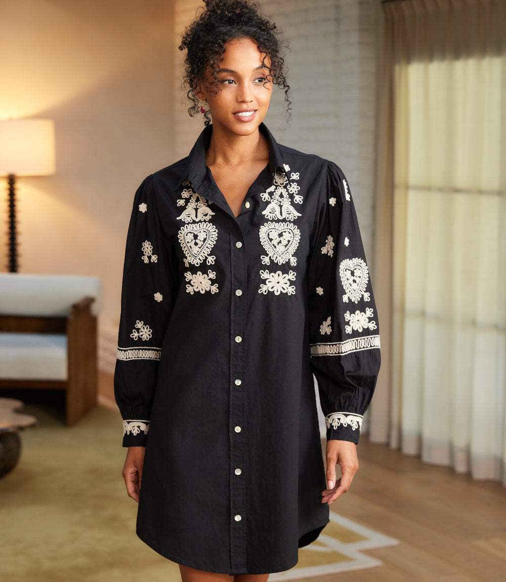 Woman wearing black Blouson Sleeve Shirtdress with cream rope-stitch embroidery and button-down front
