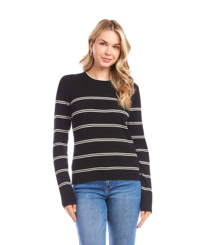 Woman wearing a slim-fit black double stripe ribbed sweater with cream horizontal stripes and crew neckline paired with blue jeans