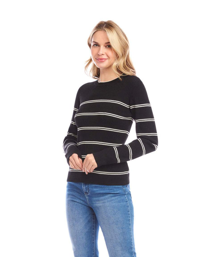 Woman wearing black and cream double stripe ribbed sweater with slim fit and crew neckline paired with blue jeans