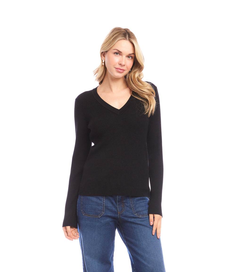 Woman wearing black ribbed V-neck sweater with slim fit and long sleeves paired with blue jeans