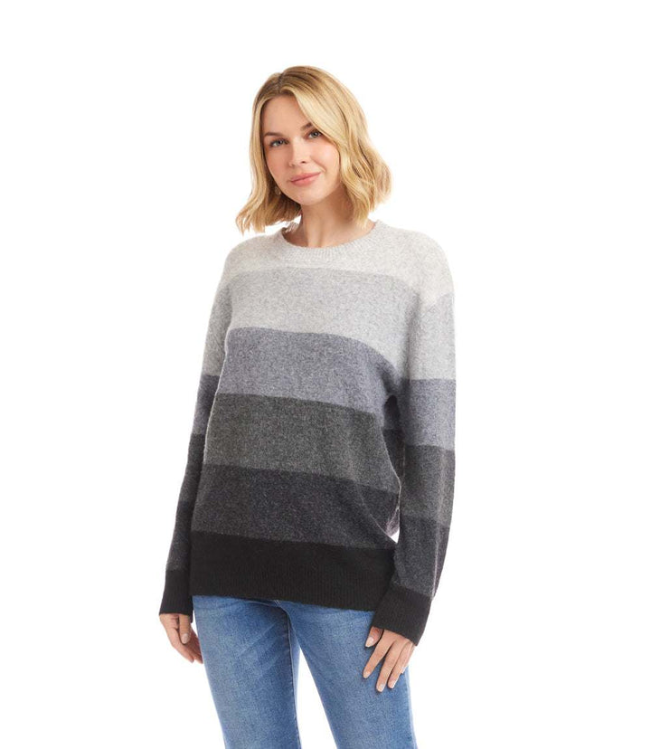 Woman wearing a multi stripe crewneck sweater with long sleeves and relaxed fit in neutral tones
