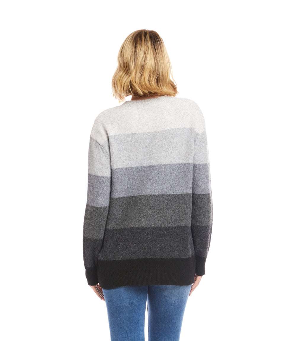 Back view of a multi stripe crewneck sweater with tonal horizontal stripes in shades of gray, worn by a person with short blonde hair and paired with blue jeans.