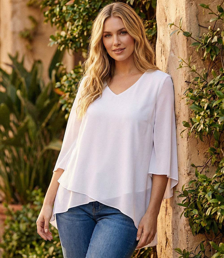 Plus size bracelet sleeve asymmetric top in silky crepe with layered hem and flare sleeves